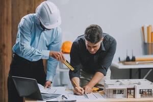 Team Engineers with draft plan of building on constructing site. Engineer work on site. engineer visit and inspection site engineer. Inspector engineer check and working on site. photo