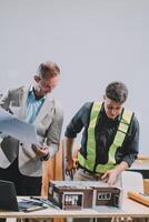 Team Engineers with draft plan of building on constructing site. Engineer work on site. engineer visit and inspection site engineer. Inspector engineer check and working on site. photo