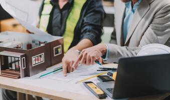 Team Engineers with draft plan of building on constructing site. Engineer work on site. engineer visit and inspection site engineer. Inspector engineer check and working on site. photo