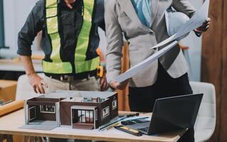 Team Engineers with draft plan of building on constructing site. Engineer work on site. engineer visit and inspection site engineer. Inspector engineer check and working on site. photo