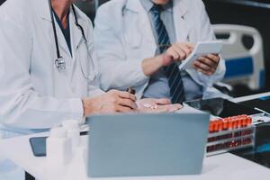 Group of medical practitioners working together and analyzing medical scan in the hospital photo