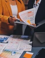 The designer team is designing the uxui system to make the uxui system work well on new phones and support system updates. Website development concept UI UX front end designer photo