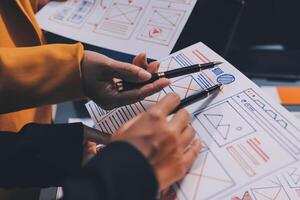 The designer team is designing the uxui system to make the uxui system work well on new phones and support system updates. Website development concept UI UX front end designer photo