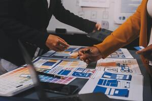 The designer team is designing the uxui system to make the uxui system work well on new phones and support system updates. Website development concept UI UX front end designer photo