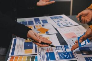 The designer team is designing the uxui system to make the uxui system work well on new phones and support system updates. Website development concept UI UX front end designer photo