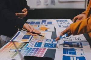 The designer team is designing the uxui system to make the uxui system work well on new phones and support system updates. Website development concept UI UX front end designer photo