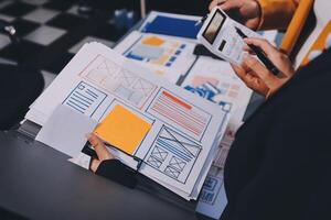 The designer team is designing the uxui system to make the uxui system work well on new phones and support system updates. Website development concept UI UX front end designer photo