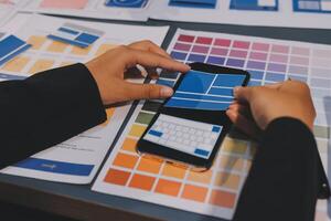 The designer team is designing the uxui system to make the uxui system work well on new phones and support system updates. Website development concept UI UX front end designer photo