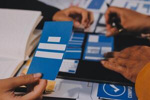 The designer team is designing the uxui system to make the uxui system work well on new phones and support system updates. Website development concept UI UX front end designer photo