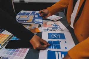 The designer team is designing the uxui system to make the uxui system work well on new phones and support system updates. Website development concept UI UX front end designer photo