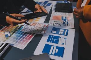 The designer team is designing the uxui system to make the uxui system work well on new phones and support system updates. Website development concept UI UX front end designer photo