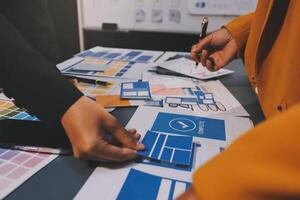 The designer team is designing the uxui system to make the uxui system work well on new phones and support system updates. Website development concept UI UX front end designer photo