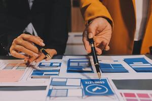 The designer team is designing the uxui system to make the uxui system work well on new phones and support system updates. Website development concept UI UX front end designer photo