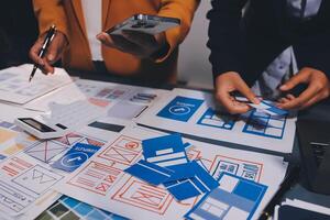 The designer team is designing the uxui system to make the uxui system work well on new phones and support system updates. Website development concept UI UX front end designer photo