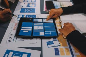 The designer team is designing the uxui system to make the uxui system work well on new phones and support system updates. Website development concept UI UX front end designer photo