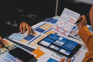 The designer team is designing the uxui system to make the uxui system work well on new phones and support system updates. Website development concept UI UX front end designer photo