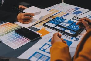 The designer team is designing the uxui system to make the uxui system work well on new phones and support system updates. Website development concept UI UX front end designer photo