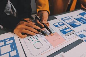 The designer team is designing the uxui system to make the uxui system work well on new phones and support system updates. Website development concept UI UX front end designer photo