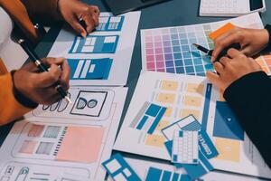 The designer team is designing the uxui system to make the uxui system work well on new phones and support system updates. Website development concept UI UX front end designer photo
