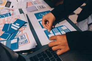 The designer team is designing the uxui system to make the uxui system work well on new phones and support system updates. Website development concept UI UX front end designer photo