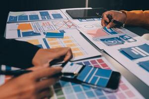 The designer team is designing the uxui system to make the uxui system work well on new phones and support system updates. Website development concept UI UX front end designer photo