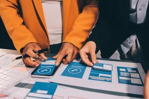 The designer team is designing the uxui system to make the uxui system work well on new phones and support system updates. Website development concept UI UX front end designer photo