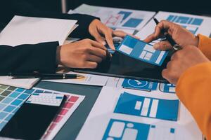 The designer team is designing the uxui system to make the uxui system work well on new phones and support system updates. Website development concept UI UX front end designer photo