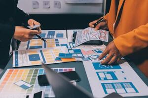The designer team is designing the uxui system to make the uxui system work well on new phones and support system updates. Website development concept UI UX front end designer photo