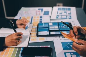 The designer team is designing the uxui system to make the uxui system work well on new phones and support system updates. Website development concept UI UX front end designer photo