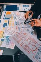 The designer team is designing the uxui system to make the uxui system work well on new phones and support system updates. Website development concept UI UX front end designer photo