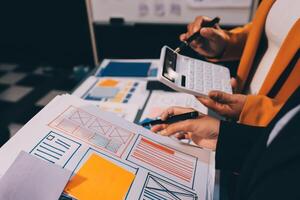 The designer team is designing the uxui system to make the uxui system work well on new phones and support system updates. Website development concept UI UX front end designer photo