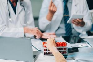 Group of medical practitioners working together and analyzing medical scan in the hospital photo