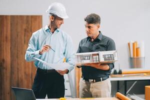 Team Engineers with draft plan of building on constructing site. Engineer work on site. engineer visit and inspection site engineer. Inspector engineer check and working on site. photo
