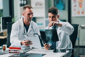 Group of medical practitioners working together and analyzing medical scan in the hospital photo