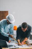 Team Engineers with draft plan of building on constructing site. Engineer work on site. engineer visit and inspection site engineer. Inspector engineer check and working on site. photo