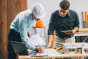 Team Engineers with draft plan of building on constructing site. Engineer work on site. engineer visit and inspection site engineer. Inspector engineer check and working on site. photo