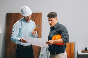 Team Engineers with draft plan of building on constructing site. Engineer work on site. engineer visit and inspection site engineer. Inspector engineer check and working on site. photo