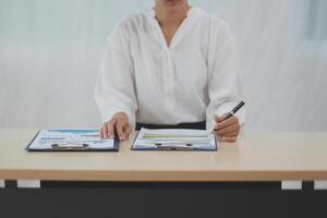 Business Documents, Auditor businesswoman checking searching document legal prepare paperwork or report for analysis TAX time,accountant Documents data contract partner deal in workplace office photo