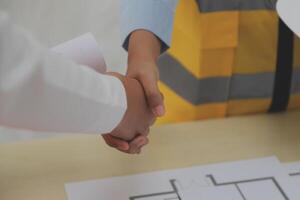 Construction and structure concept of Engineer or architect meeting for project working with partner and engineering tools on model building and blueprint in working site, contract for both companies. photo