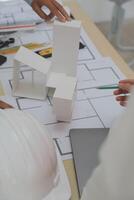 Construction and structure concept of Engineer or architect meeting for project working with partner and engineering tools on model building and blueprint in working site, contract for both companies. photo