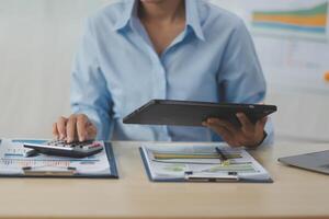 Business Documents, Auditor businesswoman checking searching document legal prepare paperwork or report for analysis TAX time,accountant Documents data contract partner deal in workplace office photo
