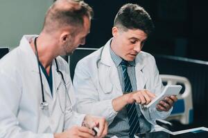 Group of medical practitioners working together and analyzing medical scan in the hospital photo