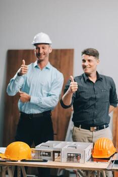 Team Engineers with draft plan of building on constructing site. Engineer work on site. engineer visit and inspection site engineer. Inspector engineer check and working on site. photo