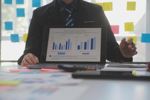 Meeting of business executives discussing analysis of the company's financial situation and business planning with partner collaboration and consultation of strategy. photo