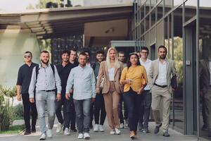 A diverse group of businessmen and colleagues walking together by their workplace, showcasing collaboration and teamwork in the company. photo