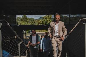 A diverse group of businessmen and colleagues walking together by their workplace, showcasing collaboration and teamwork in the company. photo