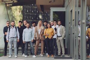 A diverse group of businessmen and colleagues walking together by their workplace, showcasing collaboration and teamwork in the company. photo