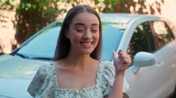 Happy excited Caucasian woman driver female glad owner buyer client joyful winner girl pointing buying new car showing automobile keys funny jump shouting yes success automobile rent transport at town video