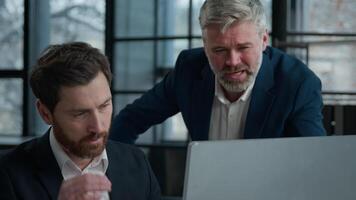 Angry man boss leader scold employee quarrel with worker unhappy with bad presentation on computer incorrect report error problem Caucasian men businessmen arguing in office meeting business conflict video