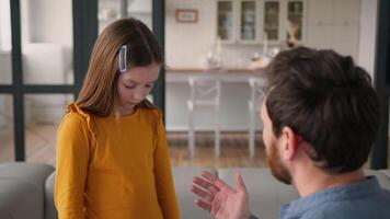 Irritated angry Caucasian dad male man speaking shout on ashamed daughter little child kid girl discipline aggression family arguing at home parent father scold for bad behavior disobedience quarrel video